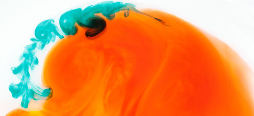 abstract orange spherical shape with turquoise florish diluting into water