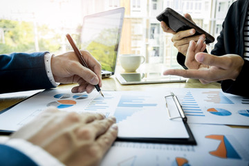 Team work process. young business managers crew working with new startup project. labtop on wood table, typing keyboard, texting message, analyse graph plans