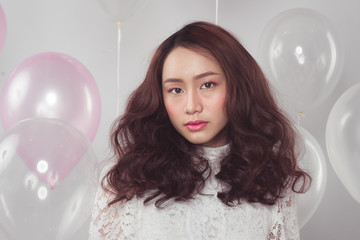 Stylish fashion asian woman with pastel balloons