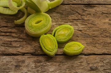 fresh raw leek slice in wooden background