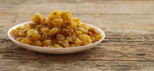 dried grapes close up on wood