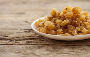 dried grapes close up on wood