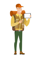 Smiling traveler holding tablet computer.