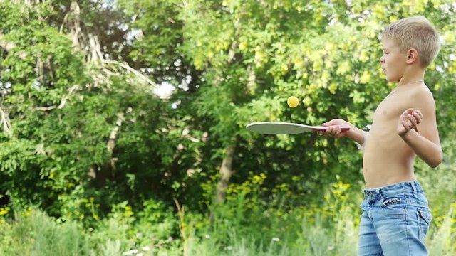 Young sports boy playing racket ball outdoors in slow motion. 1920x1080