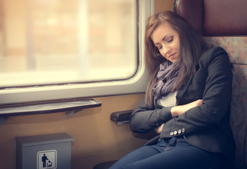 Traveler woman sleeping in a train