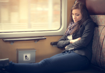 Traveler woman sleeping in a train