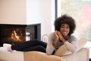 Fototapeta na wymiar black woman in front of fireplace