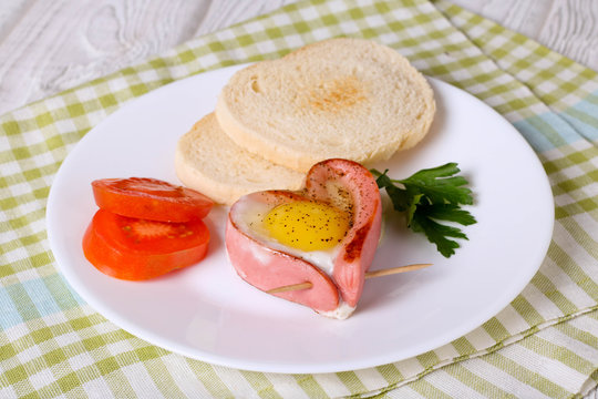sausage in a heart-shaped fried egg
