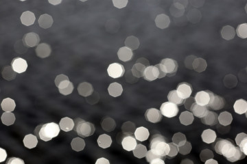 blurred image flecks of sunlight on the river