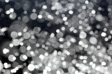 blurred image flecks of sunlight on the river