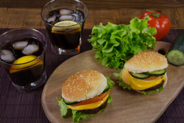 Cheeseburgers on wooden plank