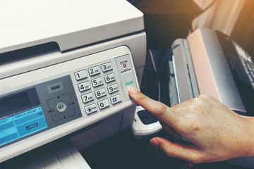 Finger pressing start button of fax machine , office equipment