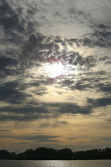 light clouds over the forest and the river