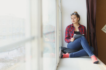 Business woman holding the tablet and wearing glasses.