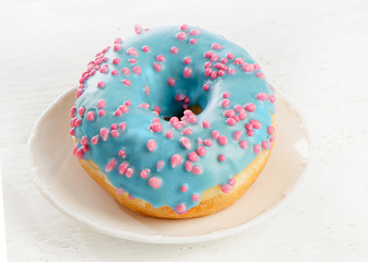 Plate with tasty glazed donut