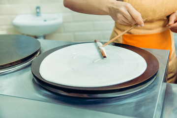 Cooking pancakes. Cooks hands cook pancakes