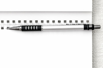 Blank sheet of notepad and the black mechanical pencil closeup.