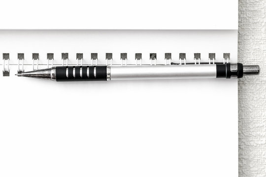 Blank sheet of notepad and the black mechanical pencil closeup.