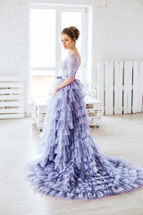 Beautiful girl in evening lilac dress