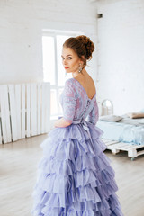 Beautiful girl in evening lilac dress