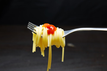 Spaghetti on a fork. Spaghetti with sauce close up.
