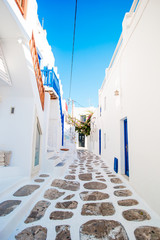 Empty narrow streets of greek old village. Beautiful architecture building exterior with cycladic style.