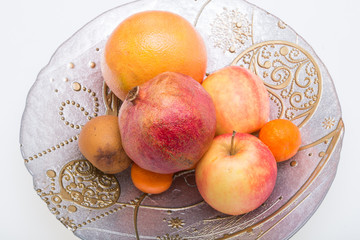 mix fresh fruits on plate isolated on white