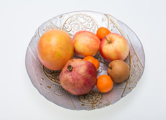 mix fresh fruits on plate isolated on white
