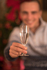 Happy young man with a glass of champagne