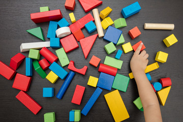 Child's hand close up playing building blocks