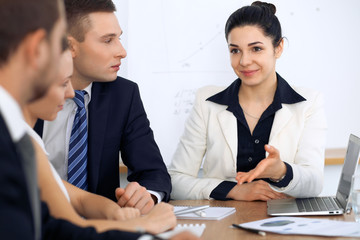 Group of business people and lawyers discussing contract papers at meeting