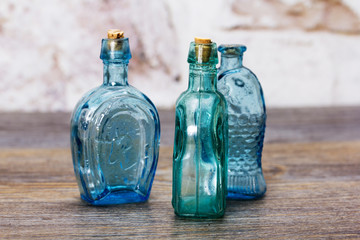 Coloured glass bottles on a rustic background