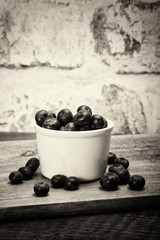 Pot of blueberries on a rustic background