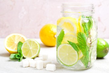 Summer drink lemonade mojito with lime, lemon and mint in mason jar 