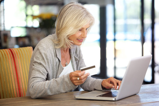 attractive woman with laptop computer and credit card