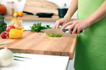 Close up of  woman's hands cooking in the kitchen. Housewife slicing ​​white bread. Vegetarian and healthily cooking concept