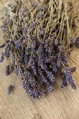 Obraz na płótnie Canvas Bundle of lavender on rustic wooden background 
