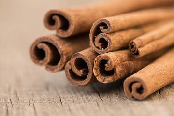 Bunch of cinnamon sticks. Christmas time. Rustic wooden table.