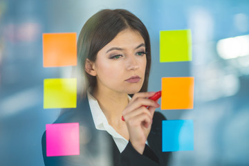 The woman writing a note on the sticker