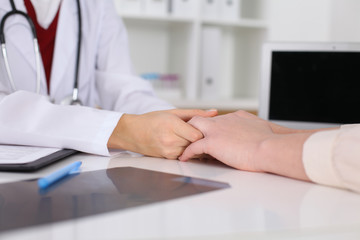 Fototapeta premium Close up of a female doctor filling up an application form while consulting patient. Medicine and health care concept