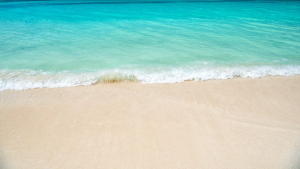 Fototapeta na wymiar wavy water background on sand