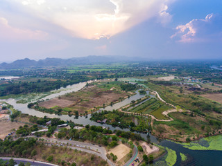 Aerial view of small river and dramatic sky