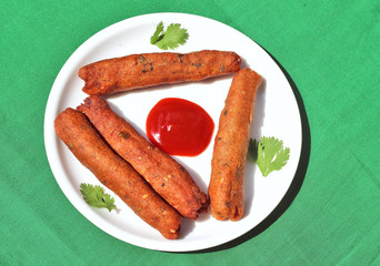 Veg seekh kabab put in white plate on green background