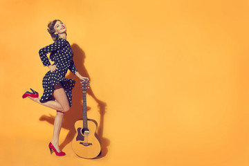 girl with guitar on yellow background in retro style