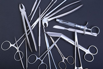 Medical and surgery instruments isolated in black mirror background