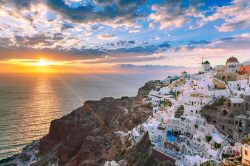 Picturesque view, Old Town of Oia or Ia on the island Santorini, white houses, windmills and church...