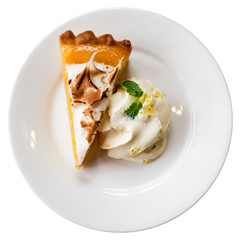 A piece of orange tart on a white plate isolated with cliping path - 141016031