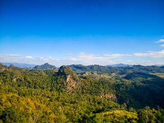 Fototapeta na wymiar Beautiful green mountain and peak with blue sky backgrounds