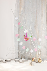 Easter holiday background with branch, painted Easter eggs and bird