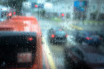 Rain droplets on car windshield, blocked traffic